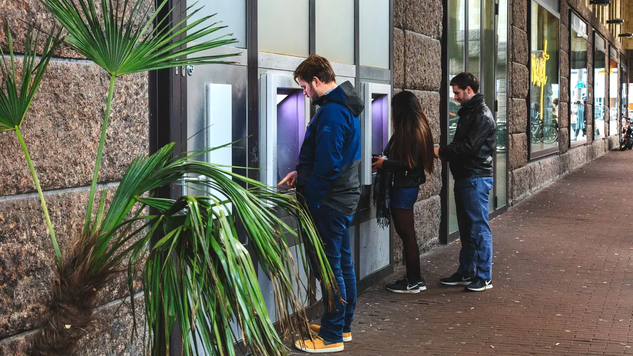people at bank atms.