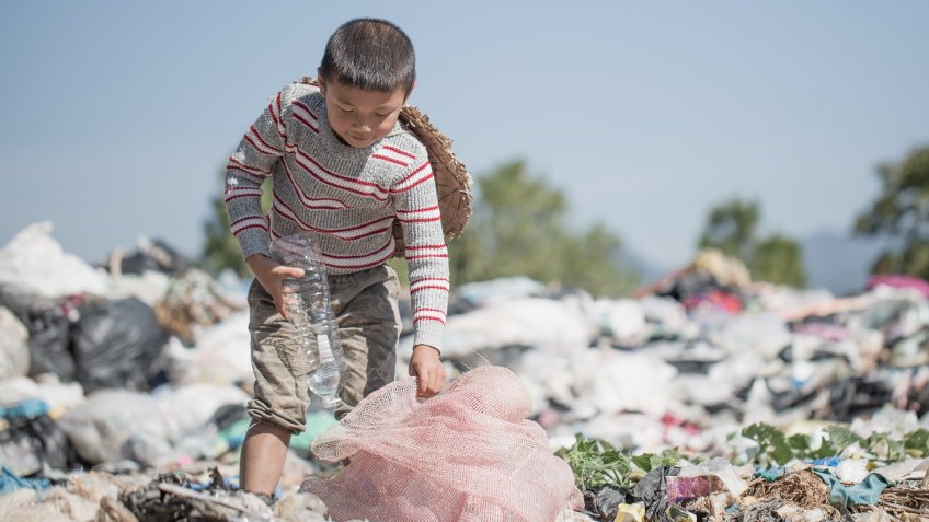 poor kid with trash