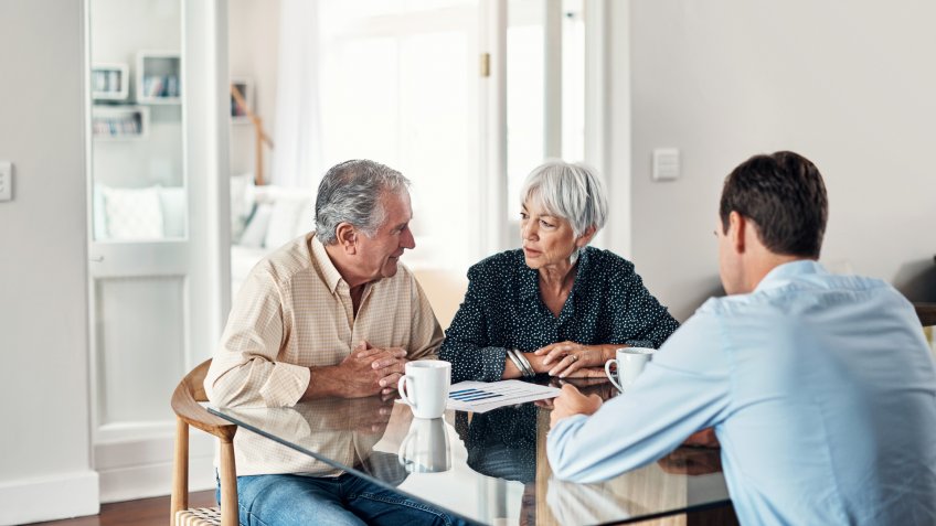 Shot of a senior couple getting advice from their financial consultant at home.