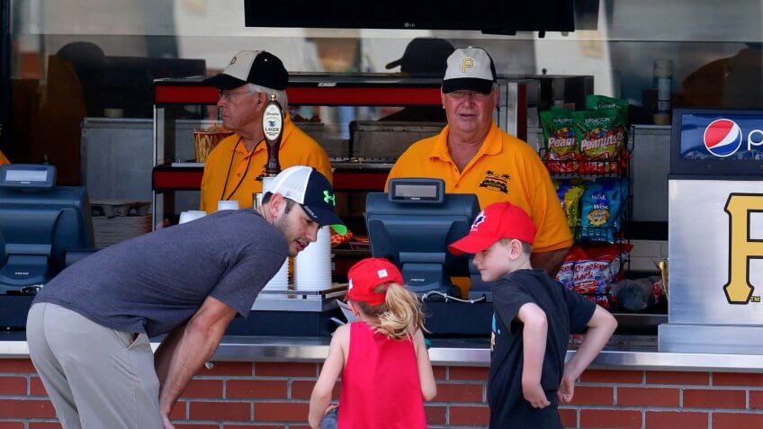 Baseball fans decide what to order during the Pittsburgh Pirates annual spring training Black and Gold intra-squad game in Bradenton, Fla.
