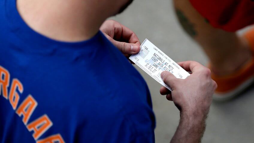 Mets Fan A New York Mets fan holds his ticket as he waits to enter the stadium for a spring training baseball game against the Washington Nationals, in Port St.