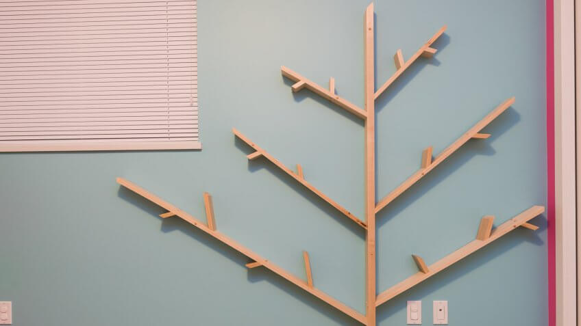 Homemade tree bookshelf made from solid maple in a kids room.