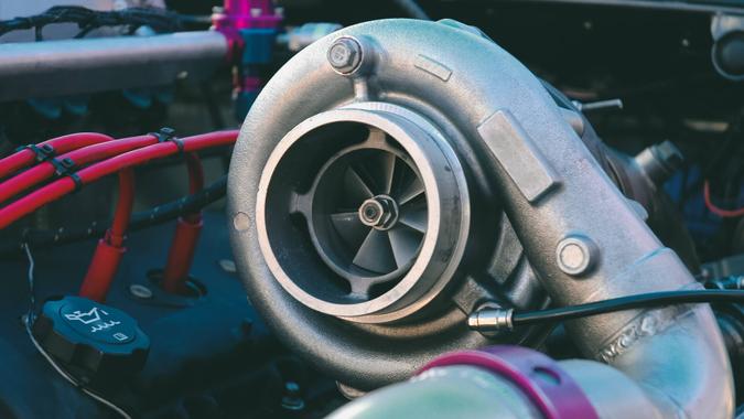 A massive turbocharger on the engine of a race car.