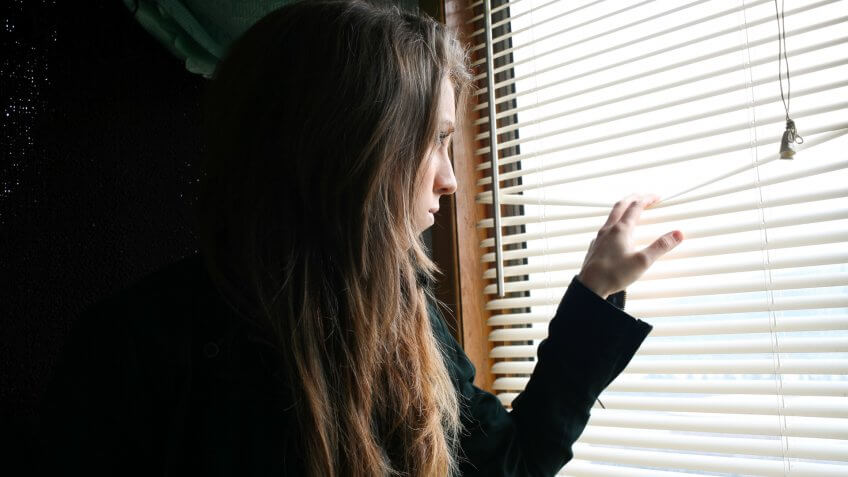 A woman looking out a window.