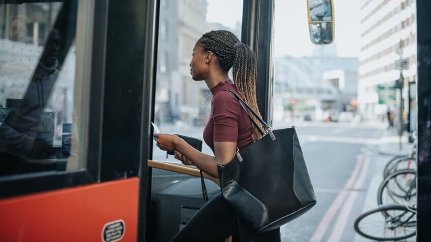 Woman getting on the bus.