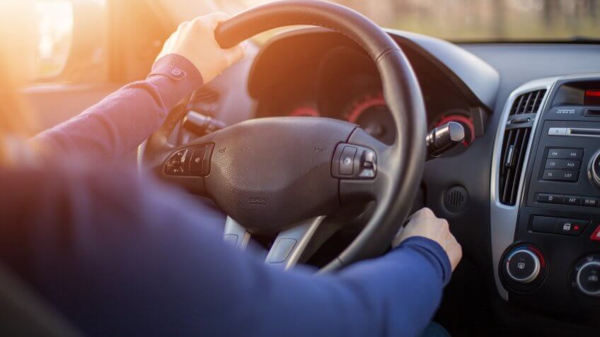 Woman starting car.
