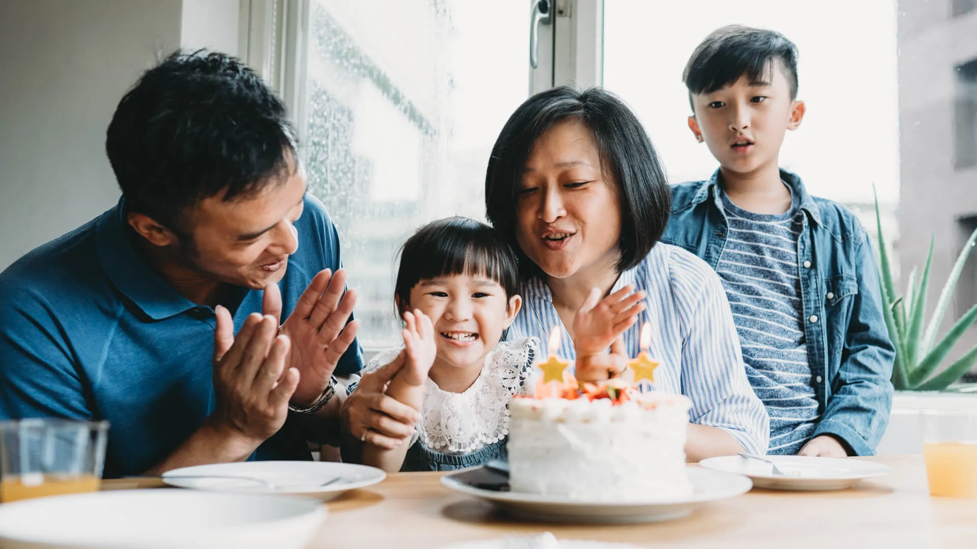 Family celebrating the birthday of the little daughter together.