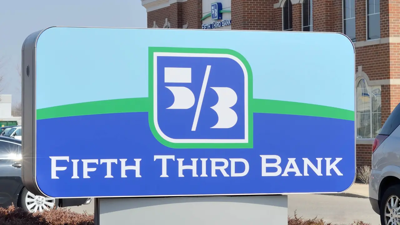 The outside facade of a bank and blue sign of Fifth Third Bank on a bright sunny day in the Midwest United States