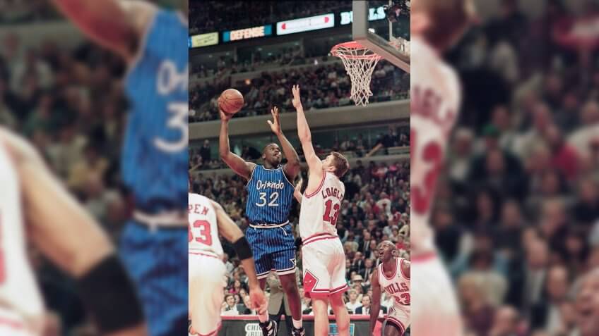 Orlando Magic's Shaquille O'Neal shoots over Chicago Bulls center Luc Longley during the Magic's 108-102 victory, in Chicago.