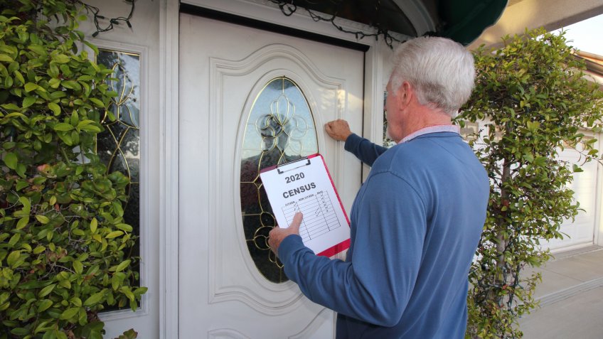 Man Canvassing a neighborhood for the 2020 census.