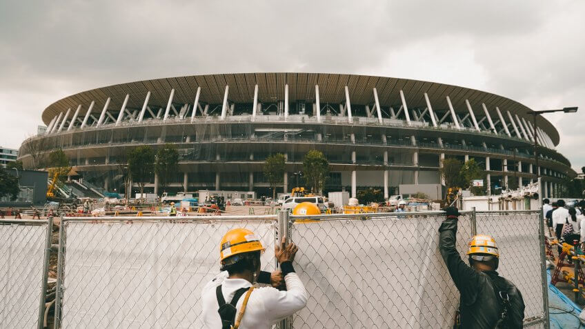 Mandatory Credit: Photo by Jae C Hong/AP/Shutterstock (10434922a)FILE - In this, file, photo, workers adjust fences at the construction site of the New National Stadium, a venue for the opening and closing ceremonies at the Tokyo 2020 Olympics, in Tokyo2020 Labor, Tokyo, Japan - 24 Jul 2019.