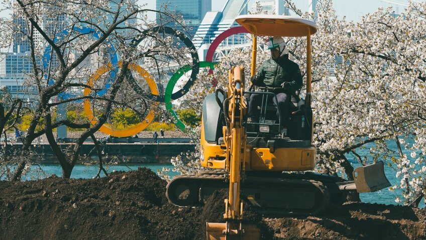 Mandatory Credit: Photo by Eugene Hoshiko/AP/Shutterstock (10592028c)Worker operates an excavator near the Olympic rings at Tokyo's Odaiba district .