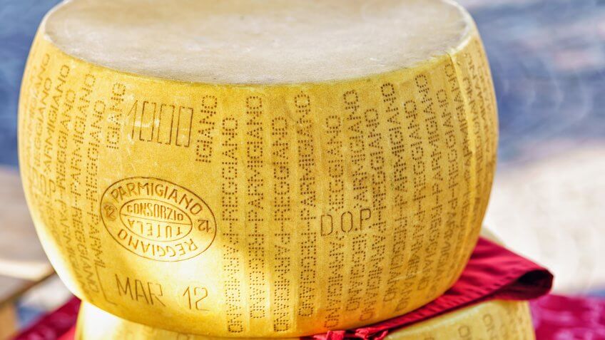 Ascona, Switzerland - August 23, 2016: Typical italian Parmigiano Reggiano cheese head on the counter in Ascona street market, Lake Maggiore, Ticino canton, in Switzerland.