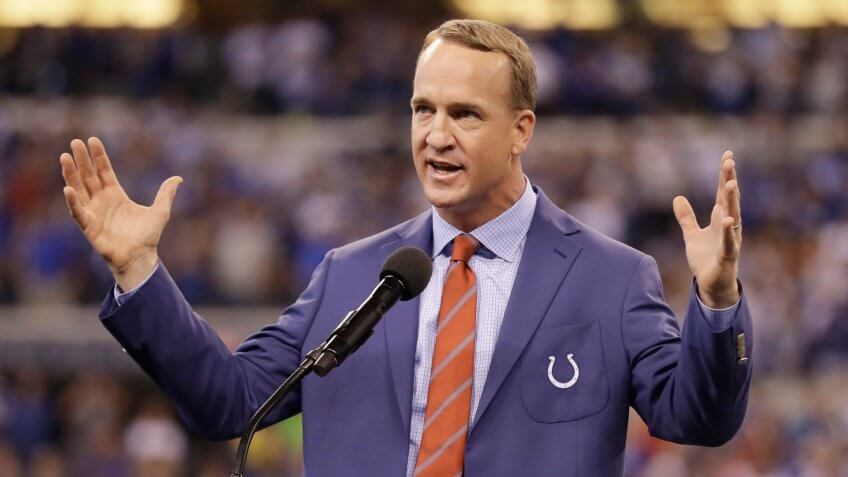 Former Indianapolis Colts quarterback Peyton Manning speaks during a halftime ceremony at an NFL football game between the Colts and the San Francisco 49ers, in Indianapolis.