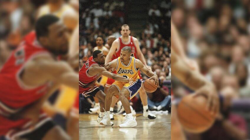 Los Angeles Lakers Derek Fisher, right, who started for injured point guard Nick Van Exel, keeps the ball away from Chicago Bulls Randy Brown during the third quarter, in Inglewood, California.