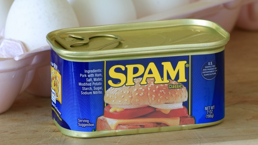 LLANO, TEXAS - AUGUST 24, 2014: Can of unopened Spam in foreground with eggs behind.