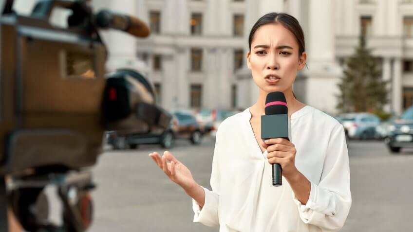 Cropped portrait of professional female reporter at work.