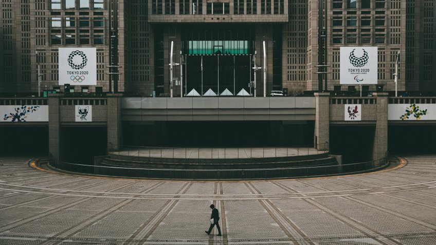 Mandatory Credit: Photo by Jae C Hong/AP/Shutterstock (10566474a)A man walks in front of the Tokyo Metropolitan Government building adorned with large banners promoting the Tokyo 2020 Olympics and Paralympics, in TokyoThe Prospects, Tokyo, Japan - 25 Feb 2020.