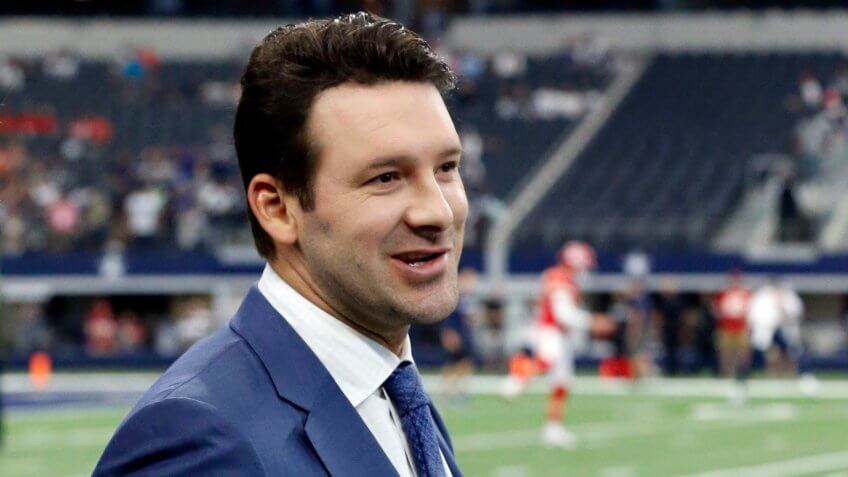 CBS football analyst Tony Romo walks across the field during warm ups before an NFL football game between the Kansas City Chiefs and Dallas Cowboys, in Arlington, Texas.