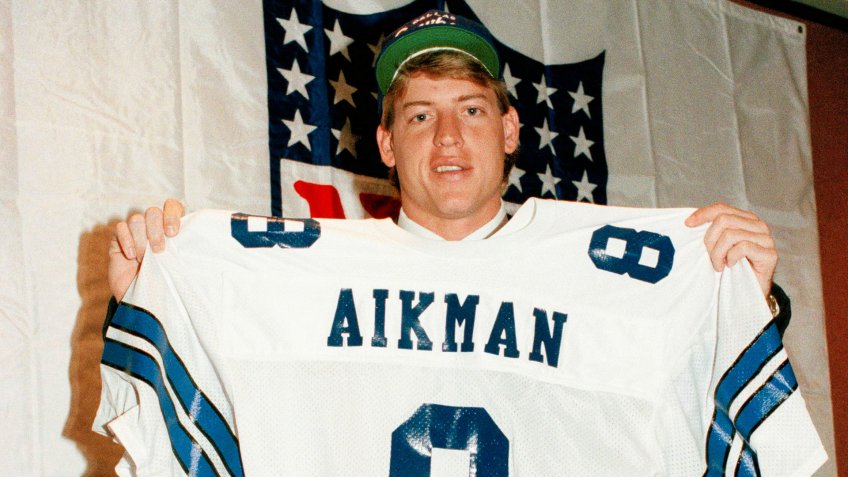 Mandatory Credit: Photo by Ray Stubblebine/AP/Shutterstock (6034683a)Troy Aikman holds up his new uniform from the Dallas Cowboys, given to the No.