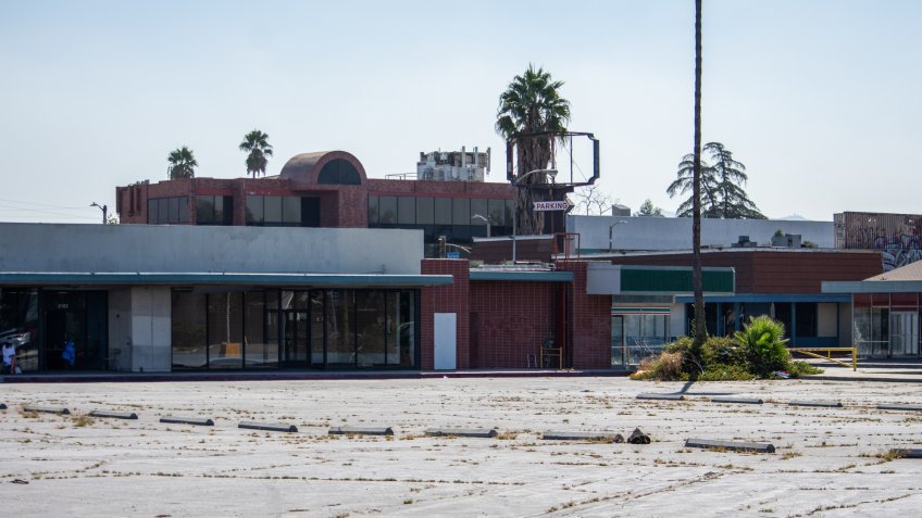North Hollywood, California / USA - September 18, 2019: Empty parking lot and abandoned storefronts at the historical Valley Plaza shopping center.