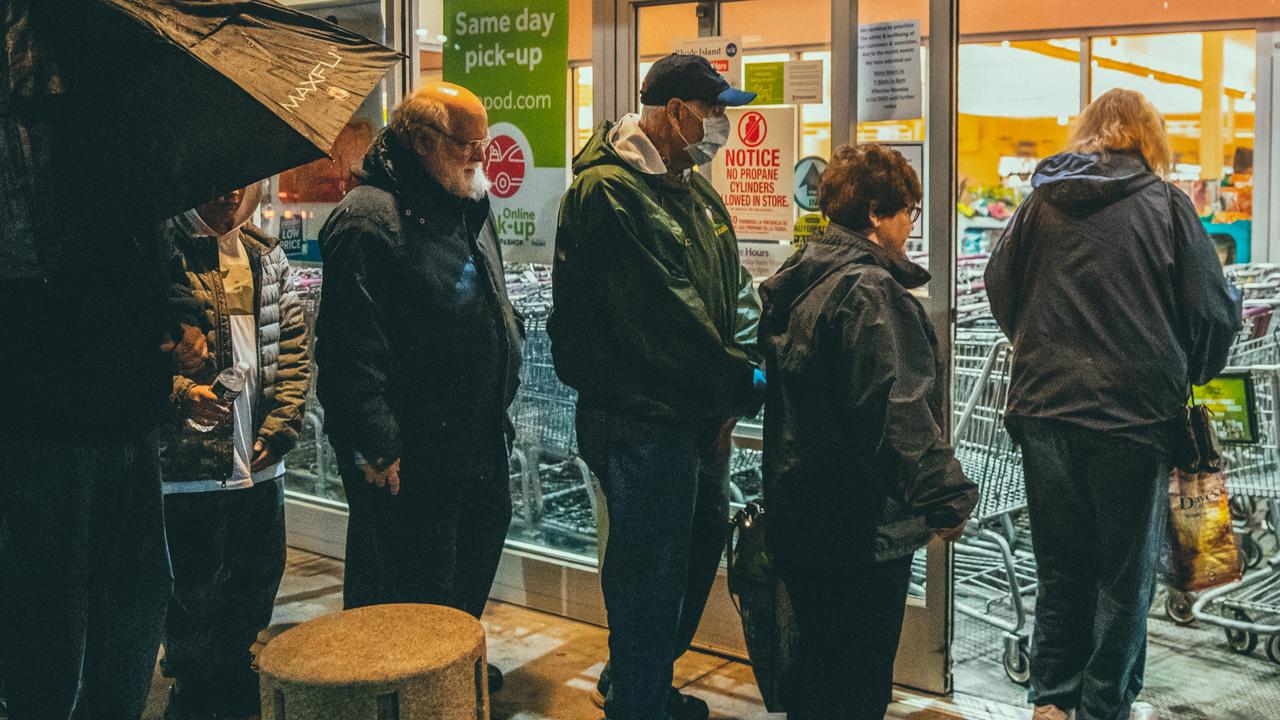 Shoppers wait to enter a Stop & Shop supermarket during hours open daily only for seniors, in North Providence, R.