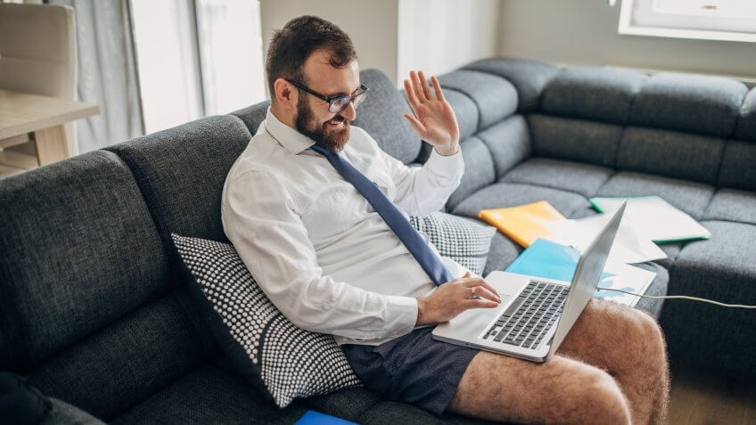 One man, businessman working from home do to coronavirus pandemic outbreak, having online meeting on laptop.