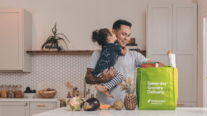 dad and child unpacking groceries - Instacart