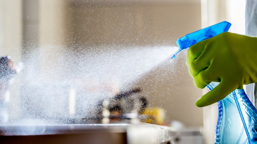 Spraying Cleaning Product on the Kitchen Counter.
