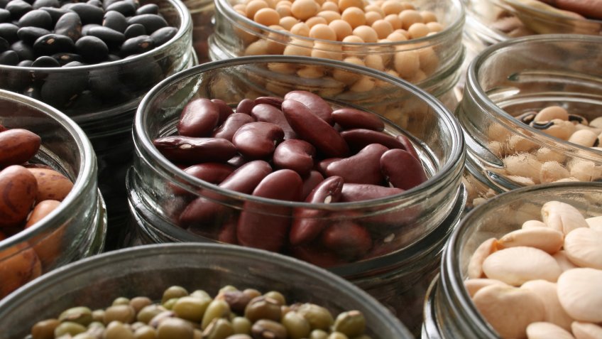 Variety of beans inside jars.
