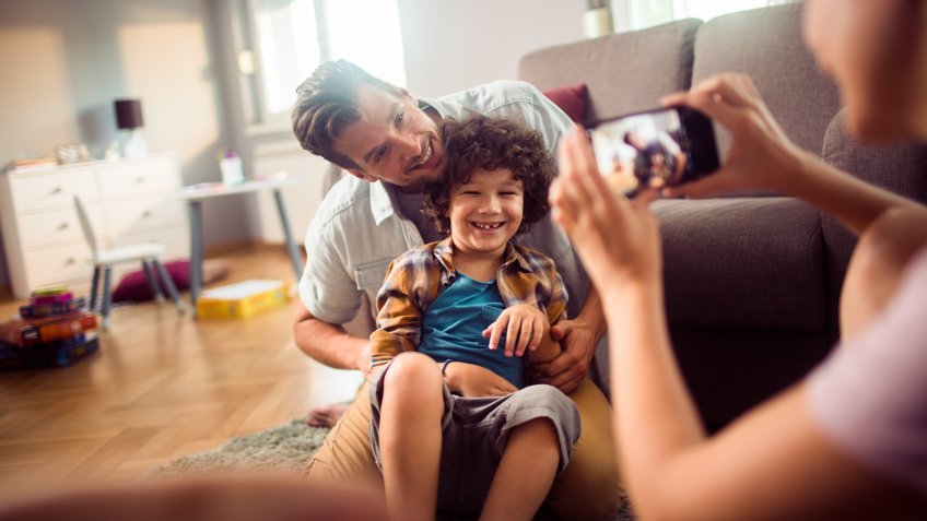 Close up of a family taking pictures together with a smart phone.