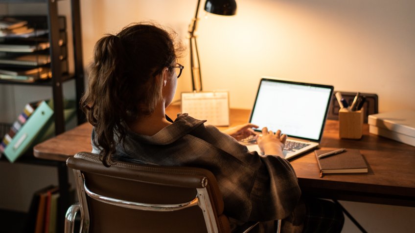 Teen girl doing homework on her laptop.