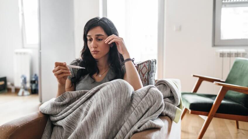 Young woman sick at home.