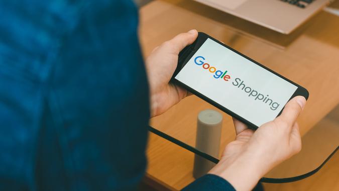 SAN FRANCISCO, US - 22 April 2019: Close up to female hands holding smartphone using Google Shopping Service, San Francisco, California, USA.