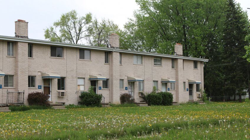 Flint, Michigan-December 30, 2017:  Low income housing with uncut grass and weeds.