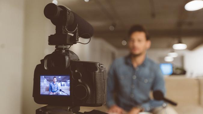 Young man talking in front of camera.