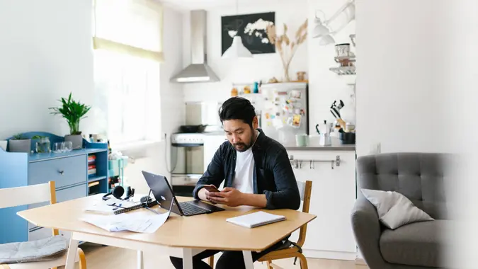 Photo series of japanese man working from home as a freelancer, making conference calls and discussing projects.
