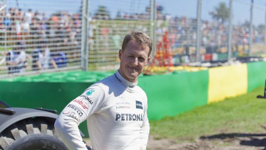 MELBOURNE, AUSTRALIA - MARCH 17: Michael Shumacher smiles to the fans after he runs wide and gets stuck in the gravel trap, at the Australian Grand Prix on March 17, 2012 in Melbourne, Australia.
