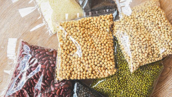 packages of dried beans shutterstock_1700532028 Cereal beans legumes peas lentils in package / product dry food with sesame soybean black eye pea mung and red bean , non perishable food.