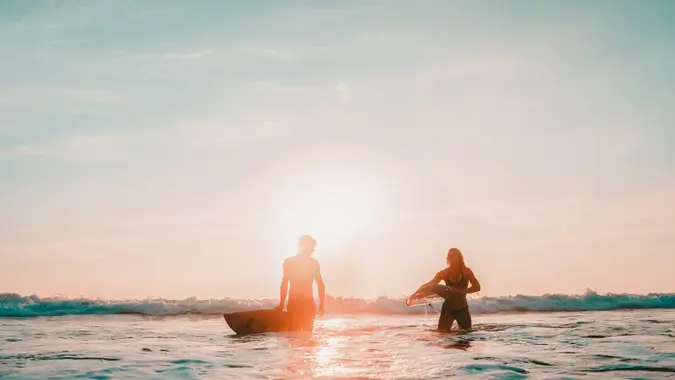 Couple returning after a long day surfing.