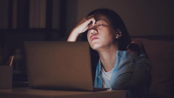 Asian woman student or businesswoman work late at night.