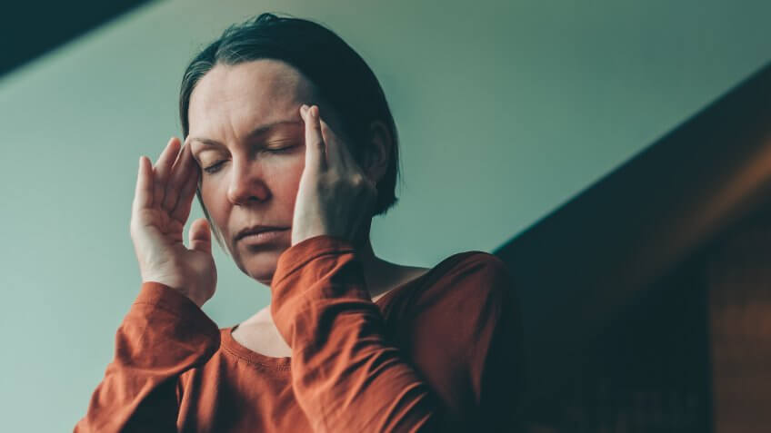 Woman with severe migraine headache, selective focus.