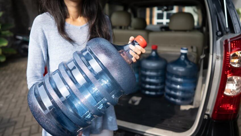 woman with water jugs for emergency