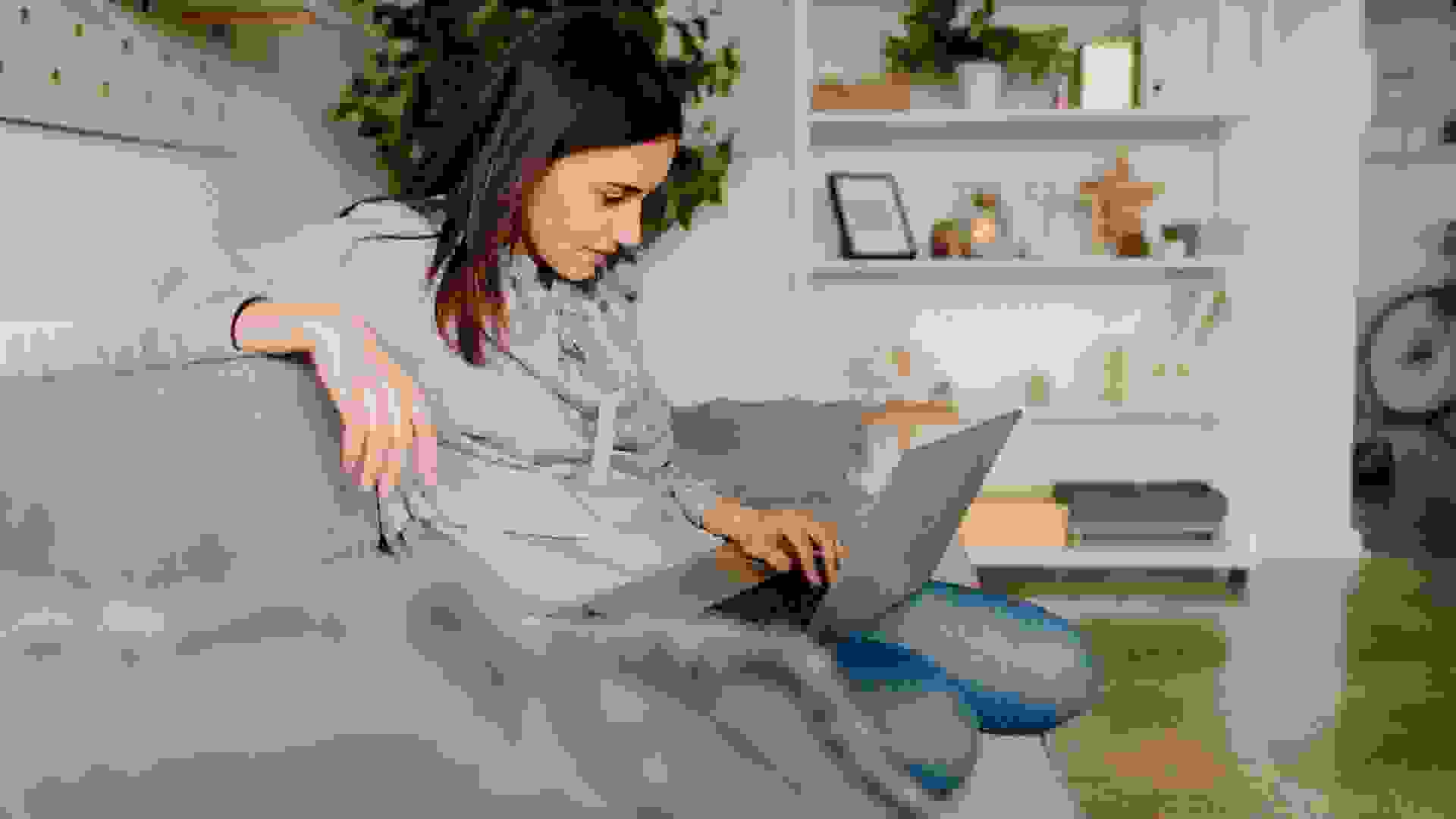 Young woman using computer at home.