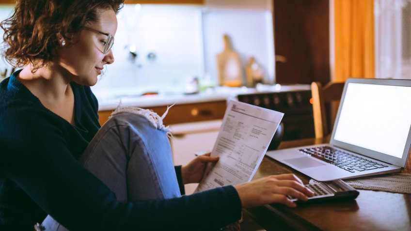 Woman going through bills at home.