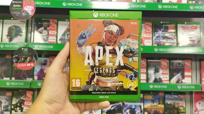Bratislava, Slovakia, october 13, 2019: Man holding Apex Legends videogame on Microsoft XBOX One console in store.