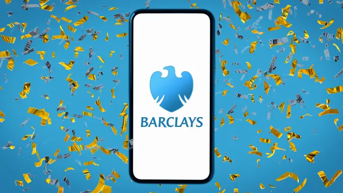 Barclays Bank logo centered on a blue backdrop with subtle gold and blue confetti elements.