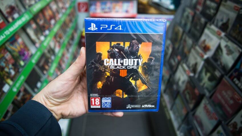 Bratislava, Slovakia, march 8 2019: Man holding Call of Duty Black Ops 4 videogame on Sony Playstation 4 console in store.