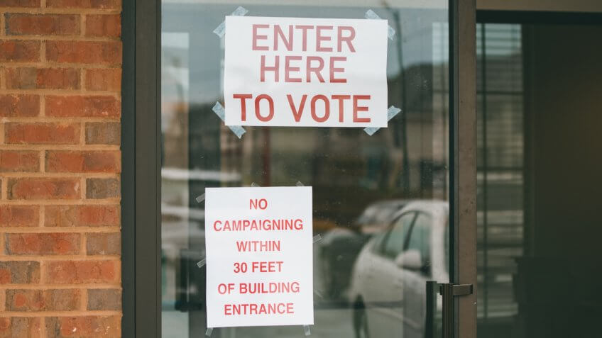 Enter Here to Vote sign on a polling location in the United States primary election on Super Tuesday.