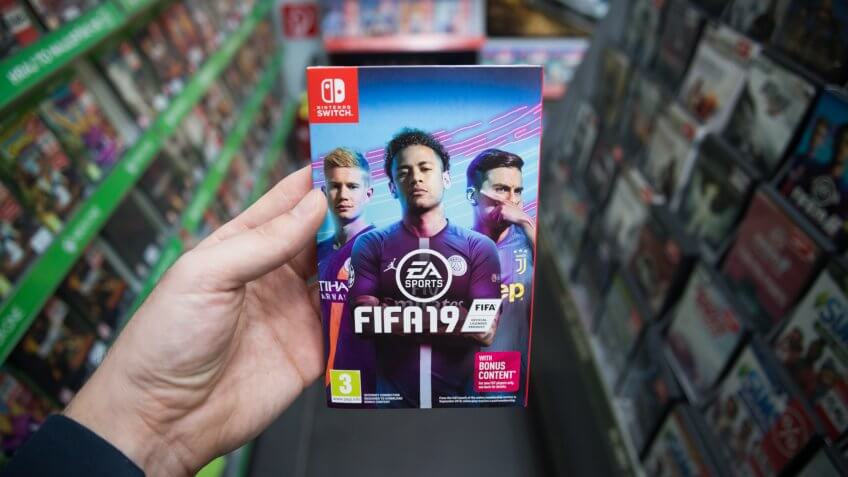 Bratislava, Slovakia, march 8, 2019: Man holding Fifa 19 videogame on Nintendo Switch console in store.